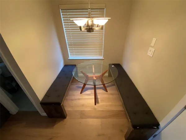 a balcony with chairs and window