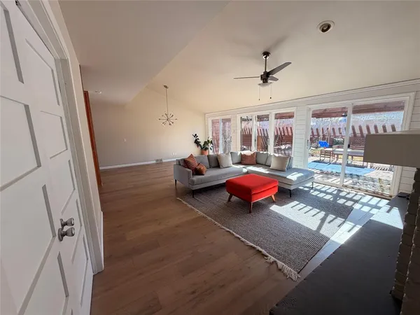 a room with wooden floor and furniture