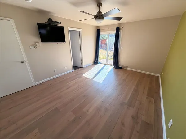 a bed sitting in a bedroom next to a wooden cabinet