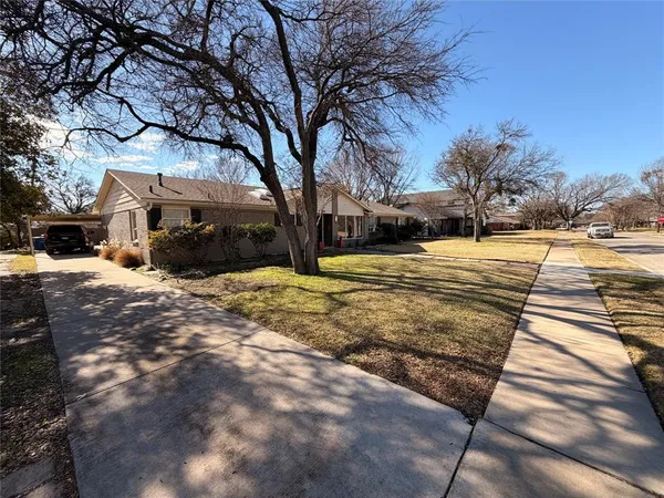 a view of a yard with snow on the road