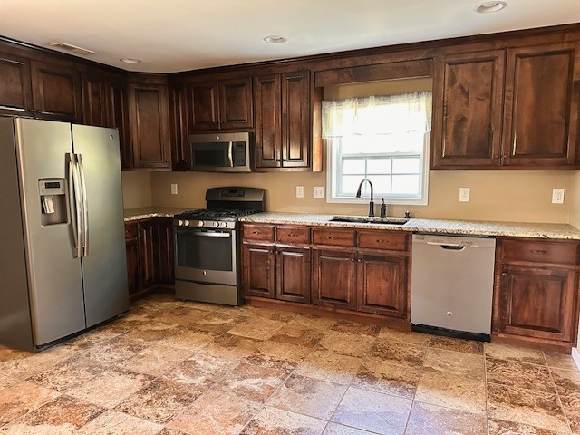 3242 Whitesell Road Culleoka, TN 38451 - Photo 11 of 17 a kitchen with stainless steel appliances granite countertop a stove a sink dishwasher a refrigerator and a microwave