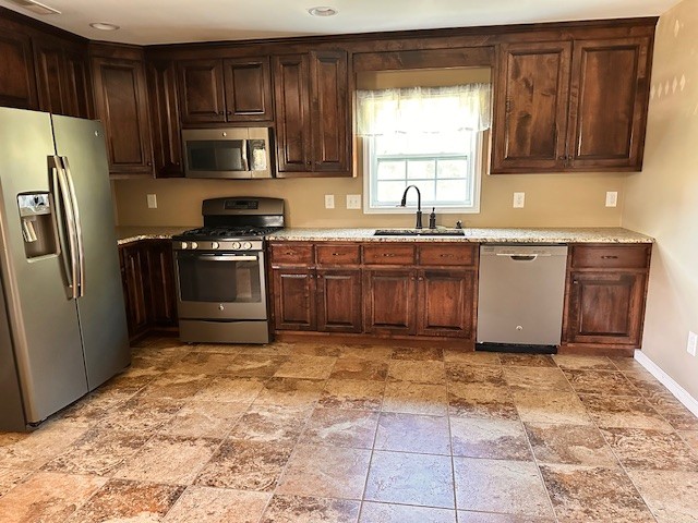 3242 Whitesell Road Culleoka, TN 38451 - Photo 9 of 17 a kitchen with stainless steel appliances granite countertop a refrigerator stove top oven and sink