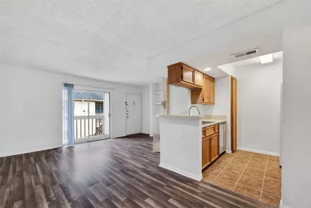 a view of a kitchen cabinets and wooden floor