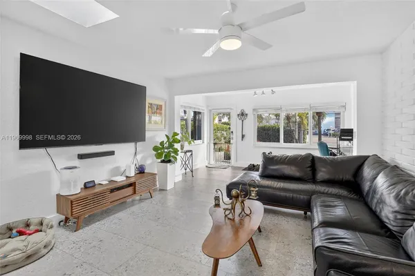 a living room with furniture and a flat screen tv