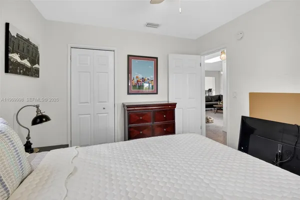 a bedroom with a bed and a dresser