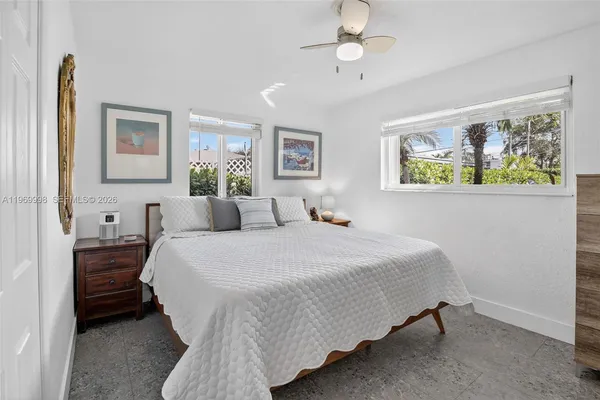 a bedroom with a bed and a painting on the wall