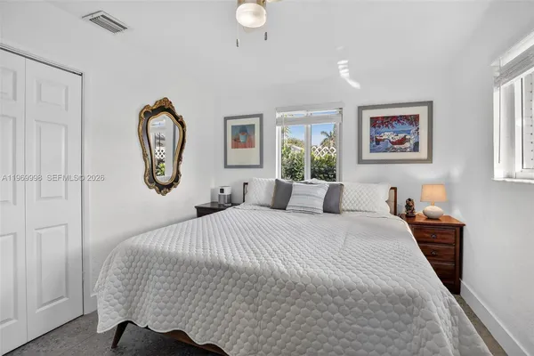 a bed room with a bed mirror and a window