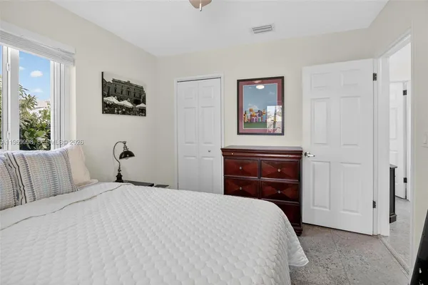 a bedroom with a bed and a tv