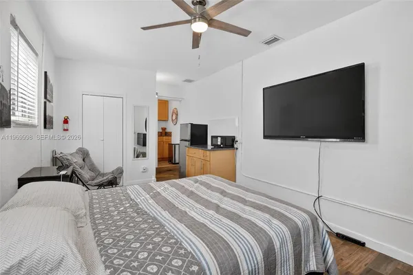 a bedroom with a bed and a flat screen tv