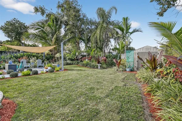 a view of outdoor space with garden and trees