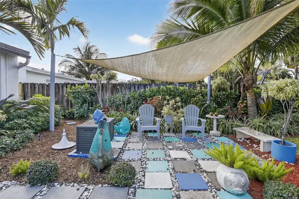 a view of a patio with table and chairs potted plants