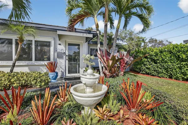 a front view of a house with a fountain