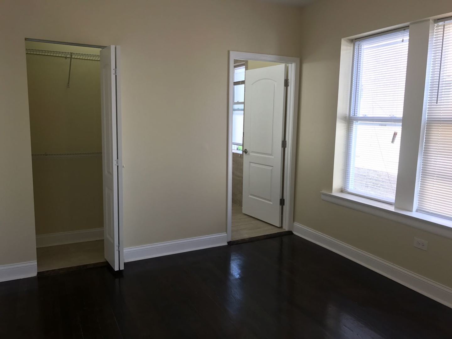 Undisclosed Address Chicago, IL 60625 - Photo 4 of 11 an empty room with wooden floor closet and windows