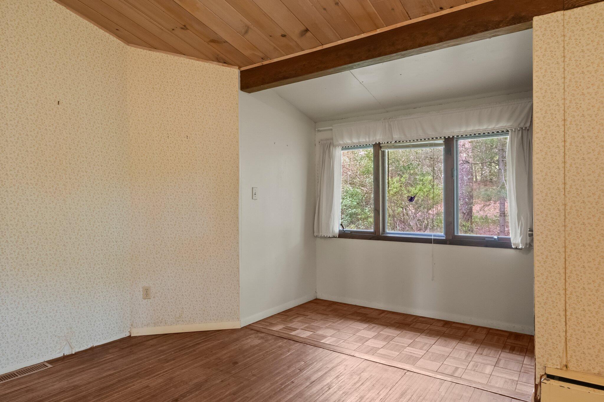 346 Setucket Road Dennis, MA 02638 - Photo 32 of 41 a view of an empty room with wooden floor and a window
