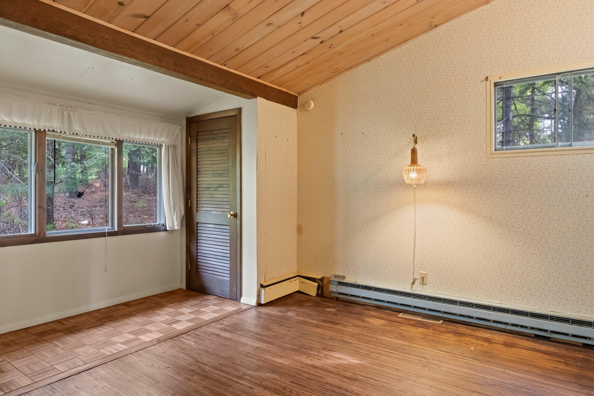 346 Setucket Road Dennis, MA 02638 - Photo 33 of 41 a view of an empty room with wooden floor and a window