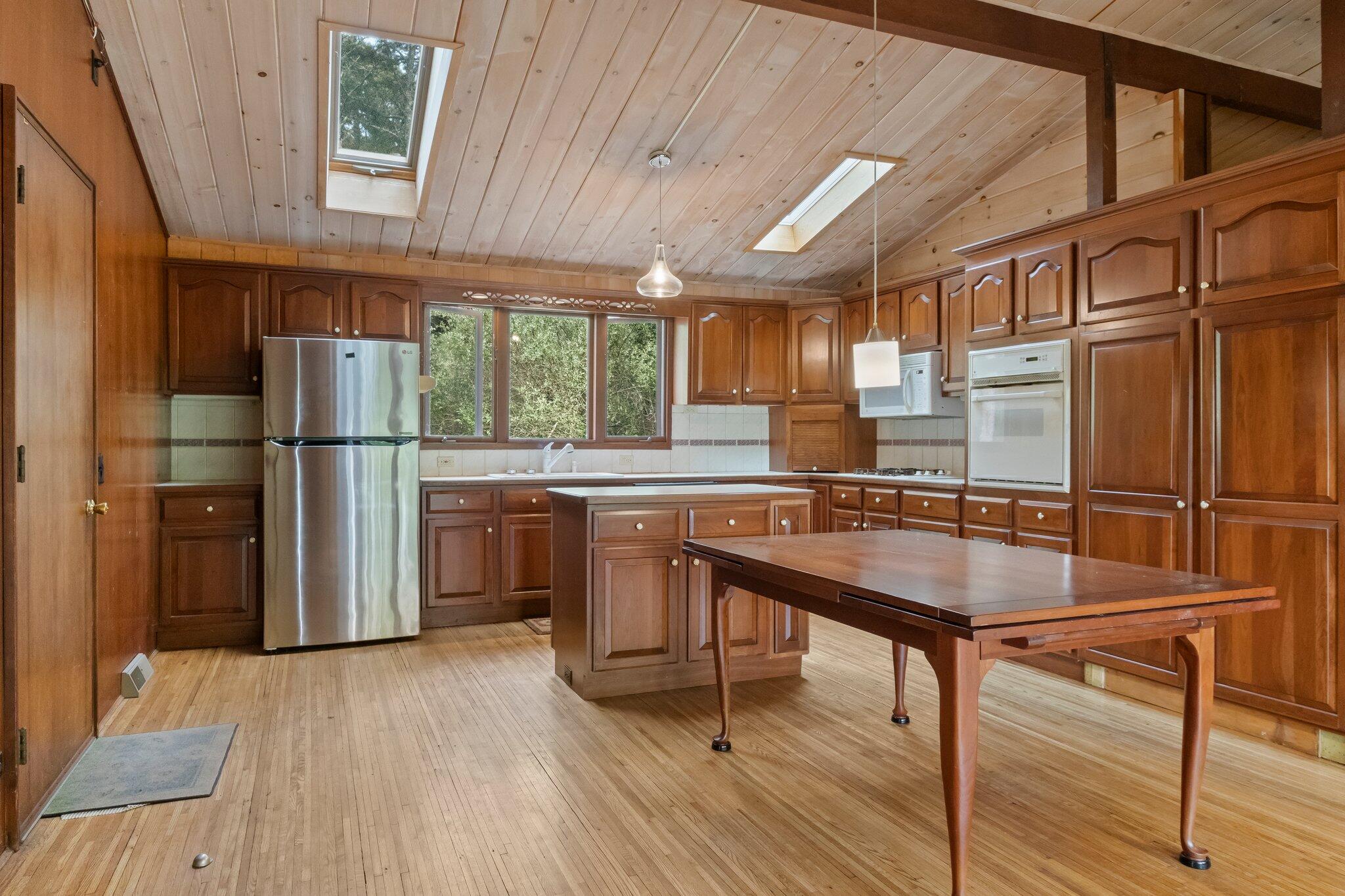 346 Setucket Road Dennis, MA 02638 - Photo 38 of 41 a kitchen with stainless steel appliances granite countertop a refrigerator a sink dishwasher a stove and white countertops with wooden floor