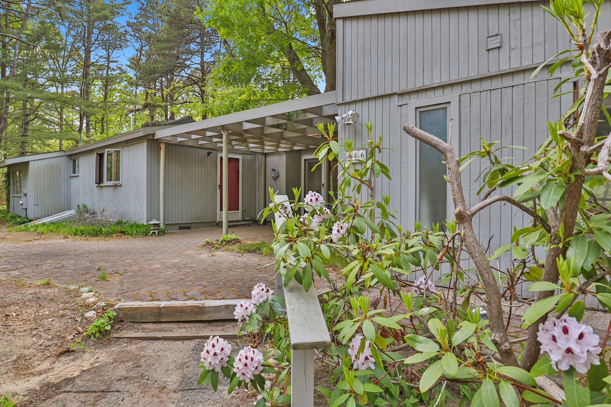346 Setucket Road Dennis, MA 02638 - Photo 5 of 41 a backyard of a house with flower plants