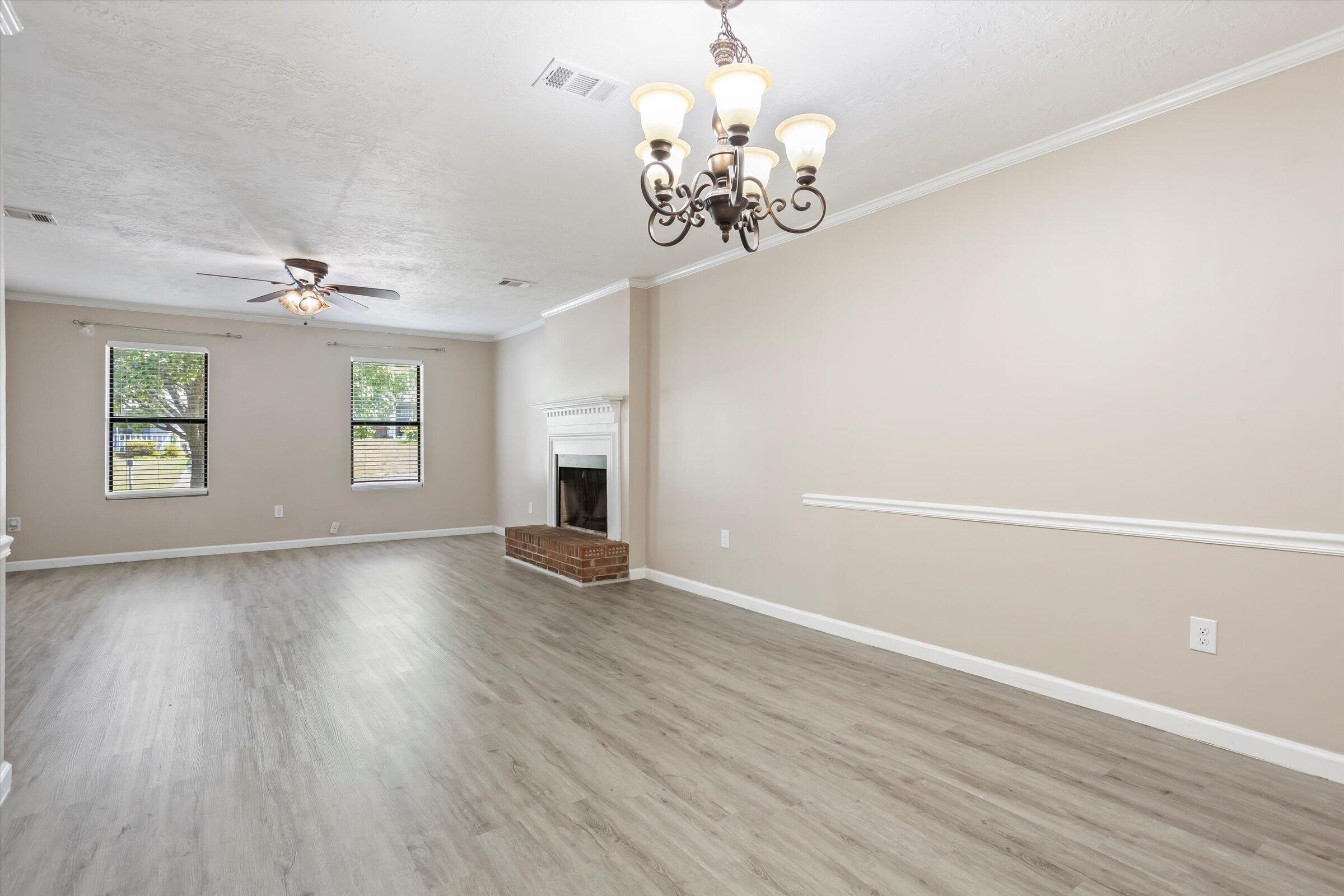305 Manchester Court Grovetown, GA 30813 - Photo 2 of 13 wooden floor in an empty room with a window