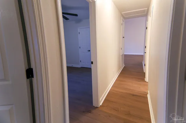 a view of a hallway with wooden floor