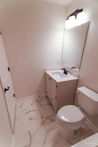 a bathroom with a sink a toilet and mirror