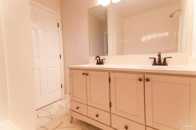 a bathroom with a sink and a mirror
