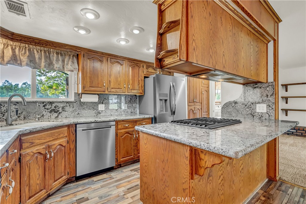 18002 Road 320 Springville, CA 93265 - Photo 29 of 56 a kitchen with stainless steel appliances granite countertop a sink a stove and a wooden cabinets