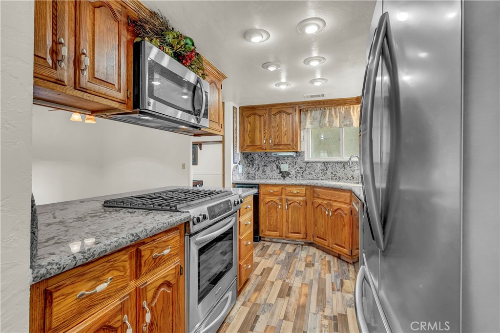 18002 Road 320 Springville, CA 93265 - Photo 31 of 56 a kitchen with stainless steel appliances granite countertop a stove and a sink