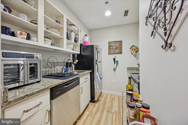 a kitchen with stainless steel appliances granite countertop a stove and a microwave