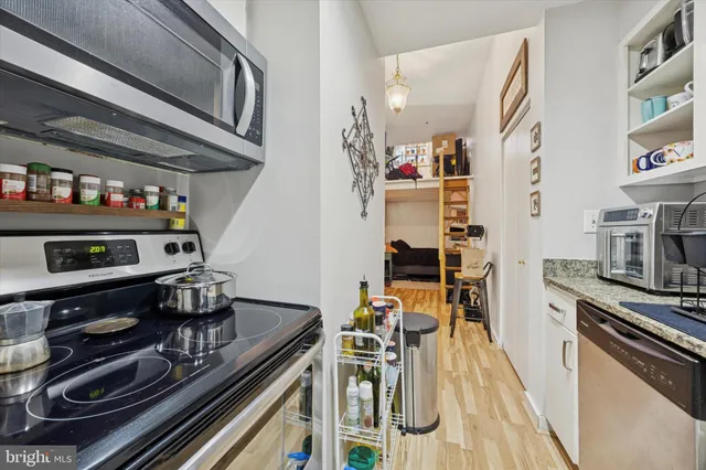 a kitchen with stainless steel appliances granite countertop a stove and a sink