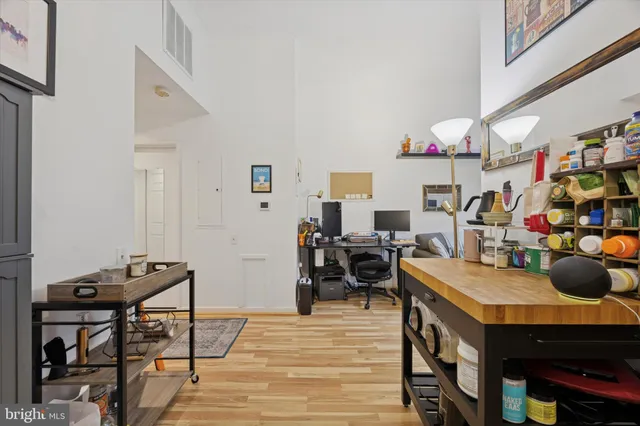 a view of a hallway with wooden floor and furniture