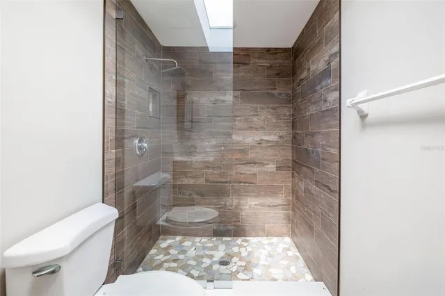 a bathroom with a toilet and a shower