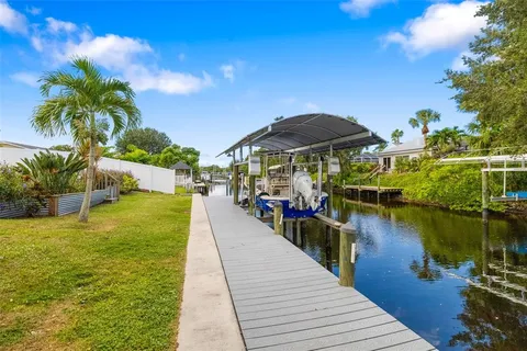 a view of a lake with a table and chairs