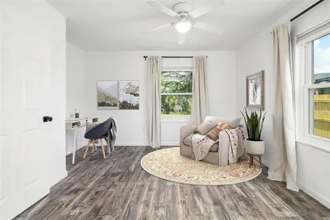 a living room with furniture and a potted plant