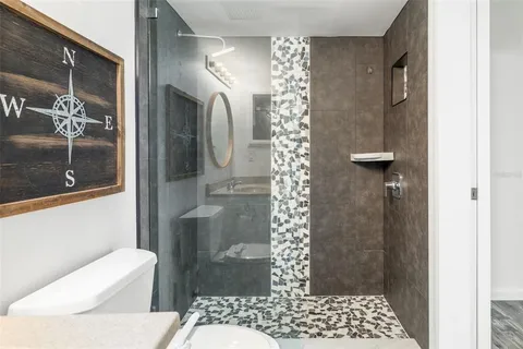 a bathroom with a toilet and shower