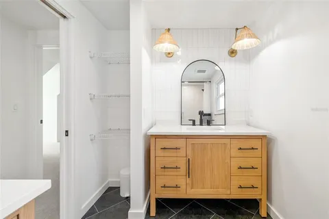a bathroom with a sink a mirror and vanity
