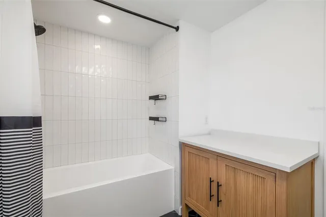 a bathroom with a bathtub and a shower