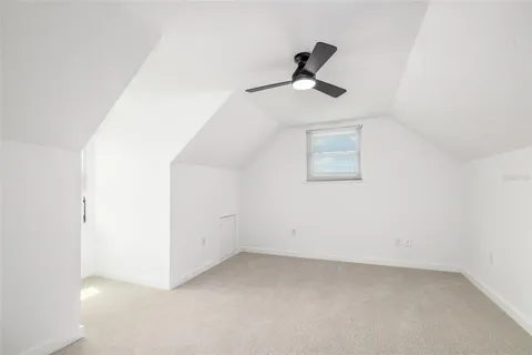 a view of empty room with ceiling fan