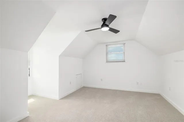 a view of empty room with ceiling fan