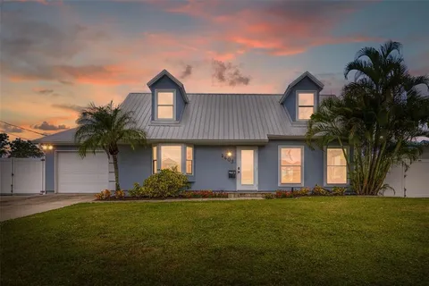 a front view of house with yard and trees