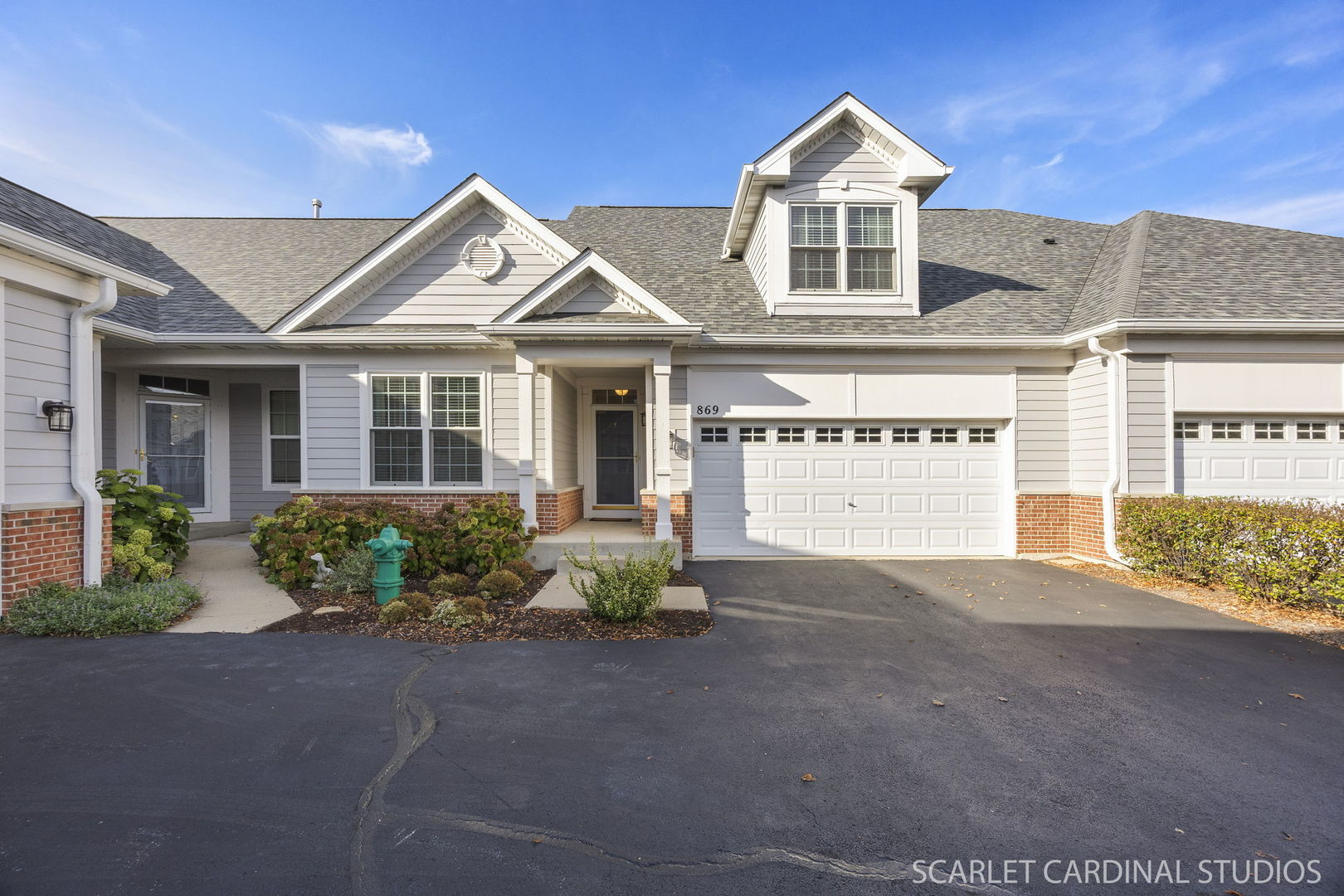 869 Cambridge Drive Batavia, IL 60510 - Photo 1 of 19 a front view of a house with a yard and garage