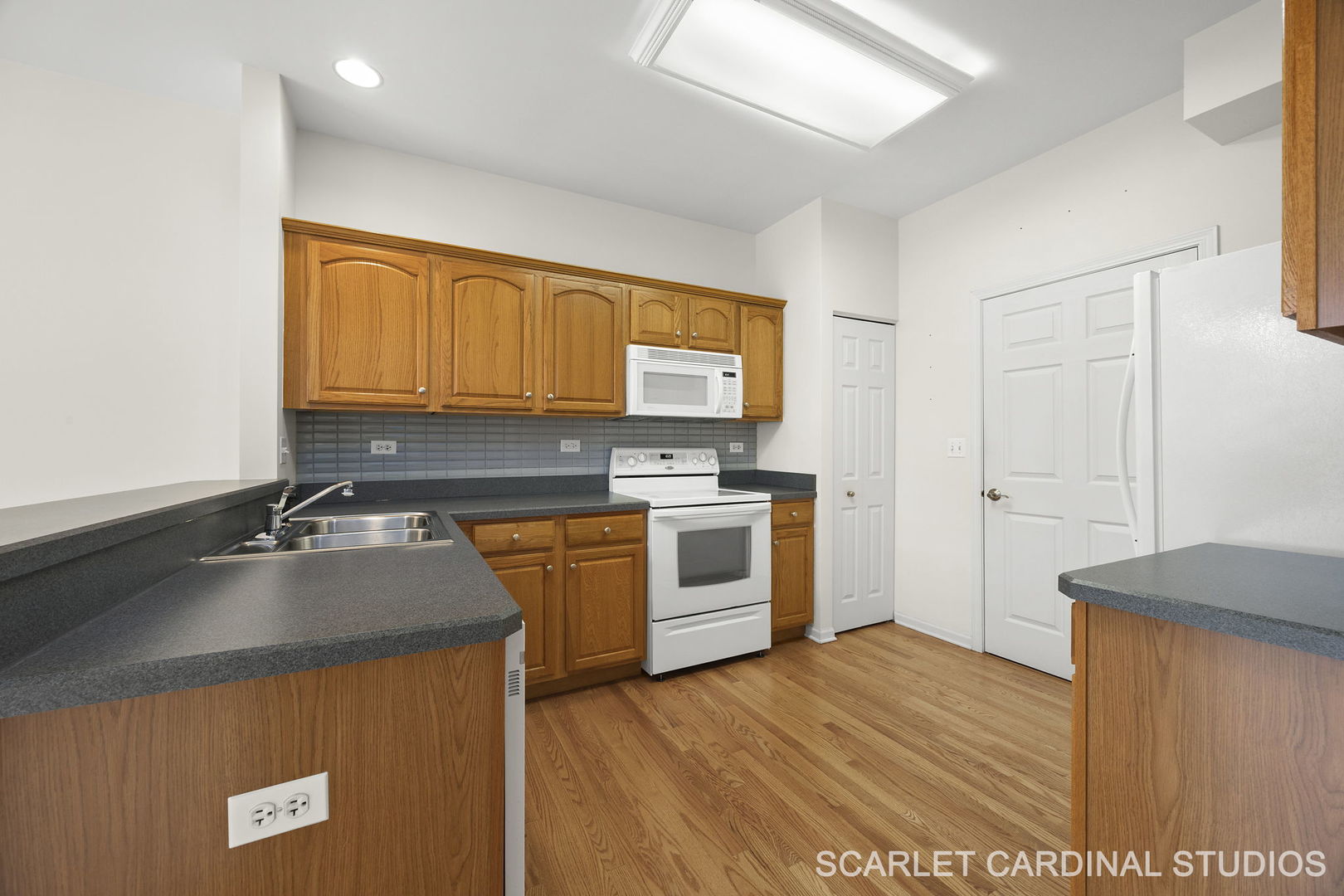 869 Cambridge Drive Batavia, IL 60510 - Photo 5 of 19 a kitchen with granite countertop a sink cabinets and stainless steel appliances