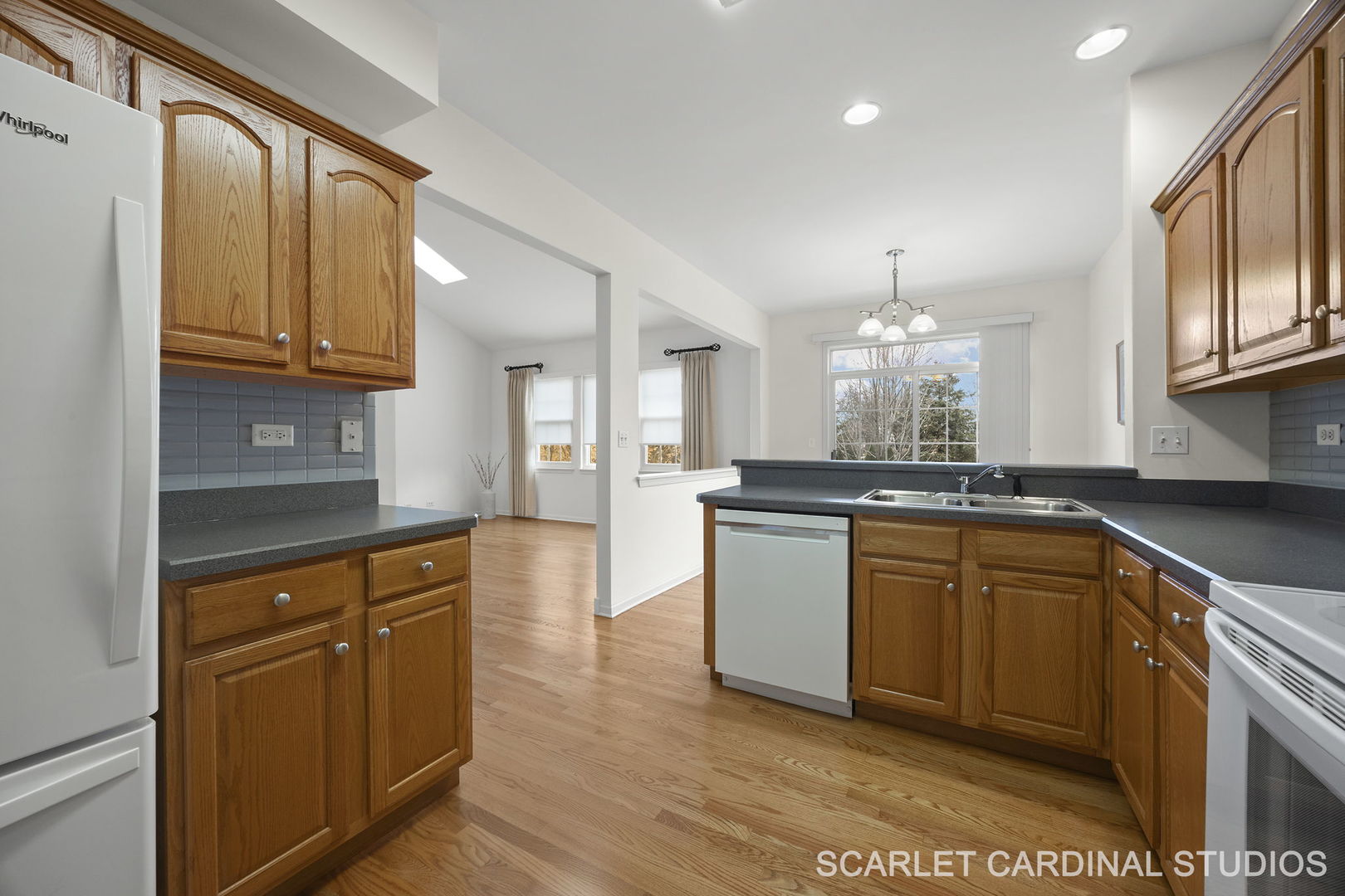 869 Cambridge Drive Batavia, IL 60510 - Photo 6 of 19 a kitchen with granite countertop a sink cabinets and wooden floor