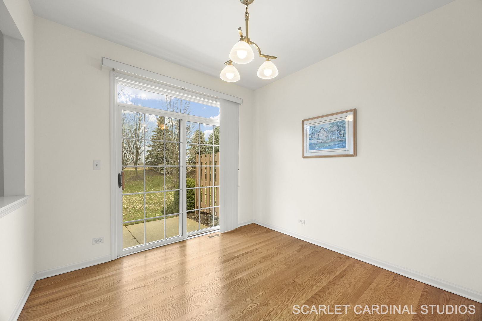 869 Cambridge Drive Batavia, IL 60510 - Photo 7 of 19 a view of an empty room with wooden floor and a window
