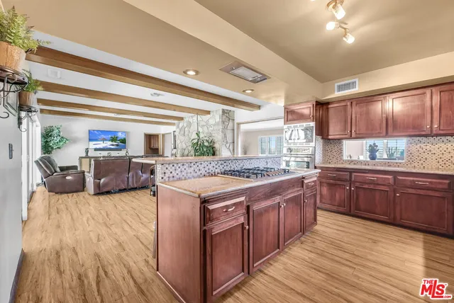 a kitchen with stainless steel appliances granite countertop a stove and cabinets