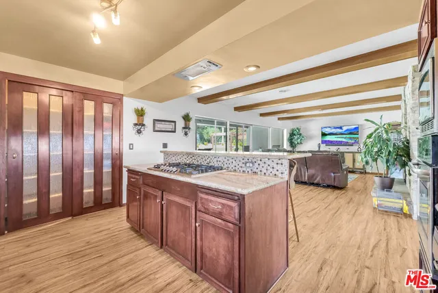 a kitchen with stainless steel appliances granite countertop a stove and a wooden floors