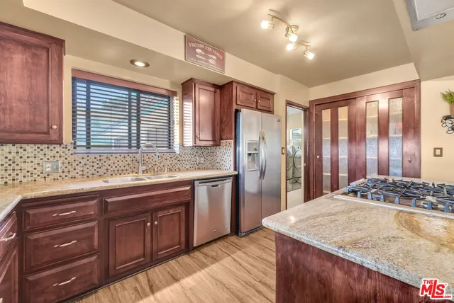 a kitchen with a sink stove and refrigerator