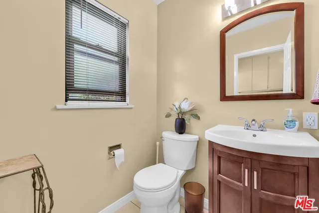 a bathroom with a toilet a sink and a mirror