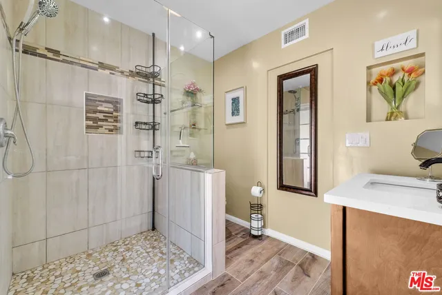 a bathroom with a sink a toilet and shower