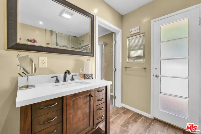 a bathroom with a sink a mirror and a shower