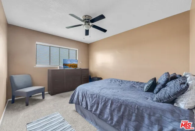 a bedroom with a bed window and couch